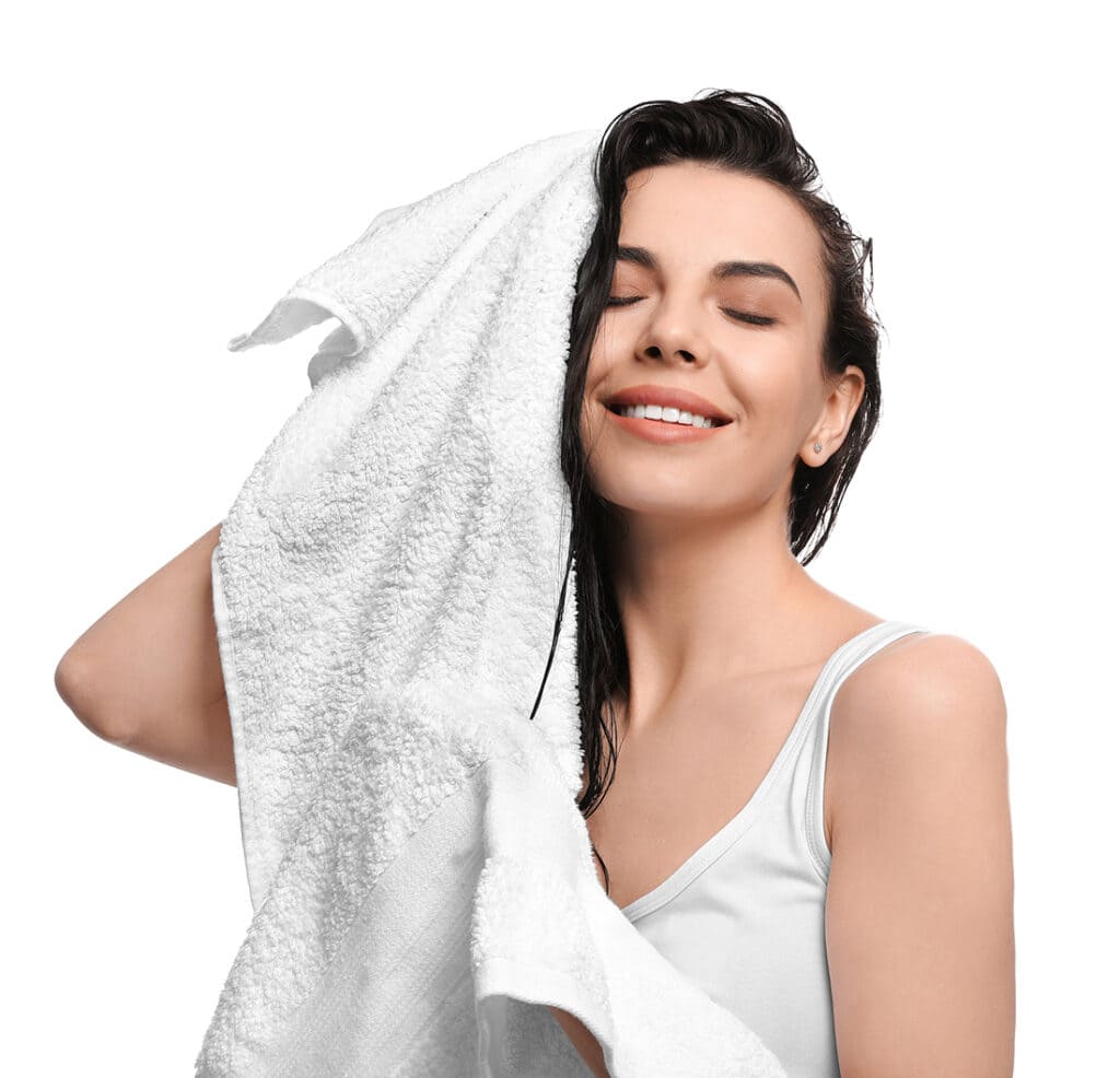 a girl dries hair with towel
